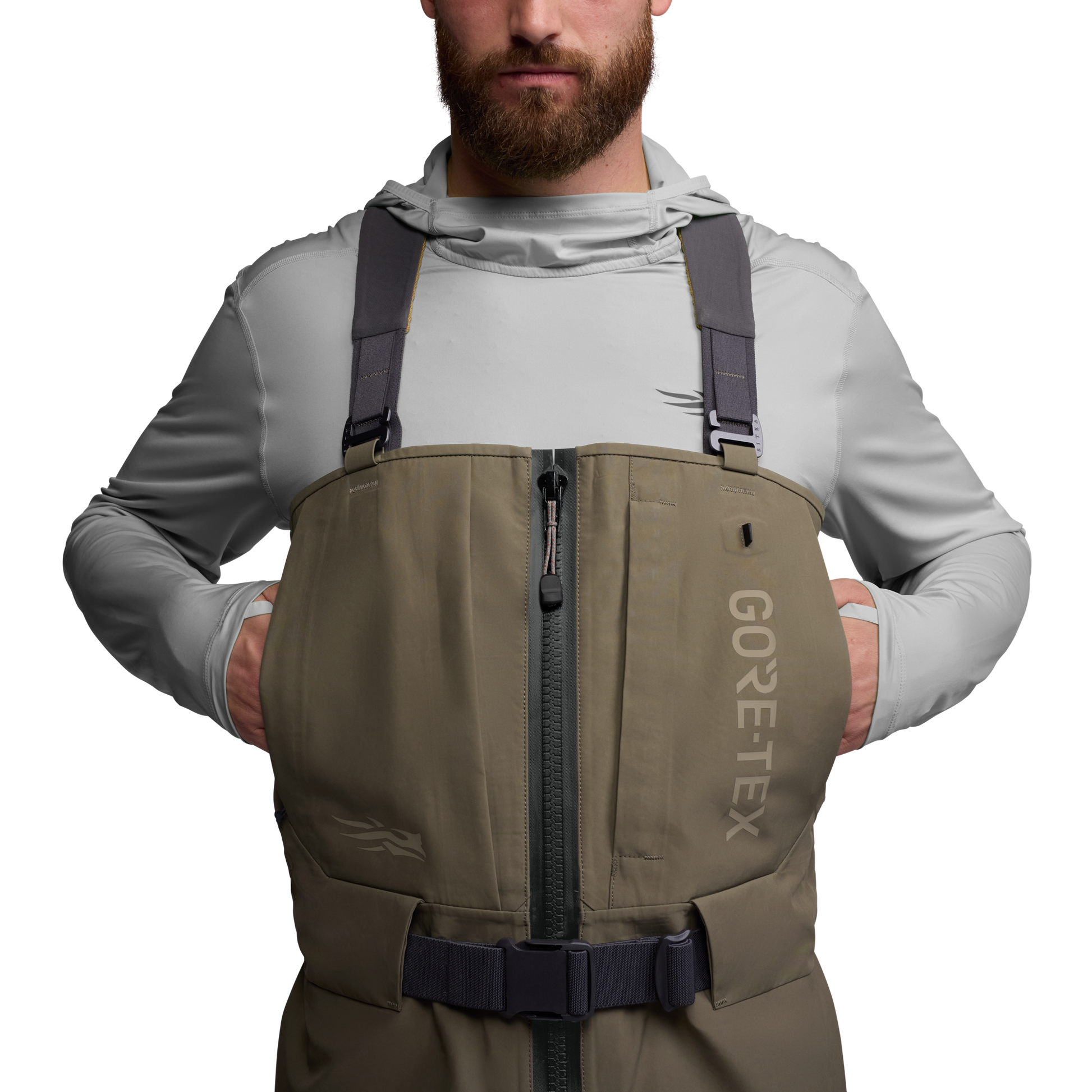 Man wearing a brown GORE-TEX vest over a light gray shirt on a white background