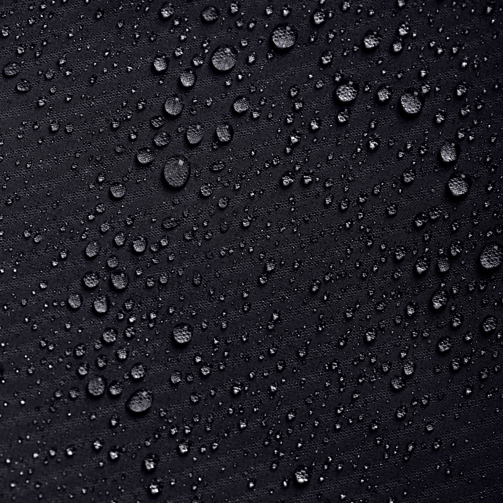 Close-up of water droplets on a black surface