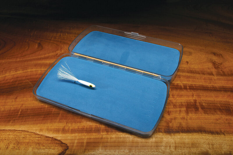 Clear plastic Bugger Barn fly box open on a wood surface, displaying a single white streamer fly on a blue foam insert.