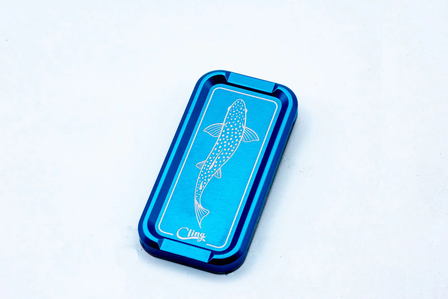 Cling Mag Grab Double Stack in vibrant blue with detailed trout engraving, made from anodized aluminum.
