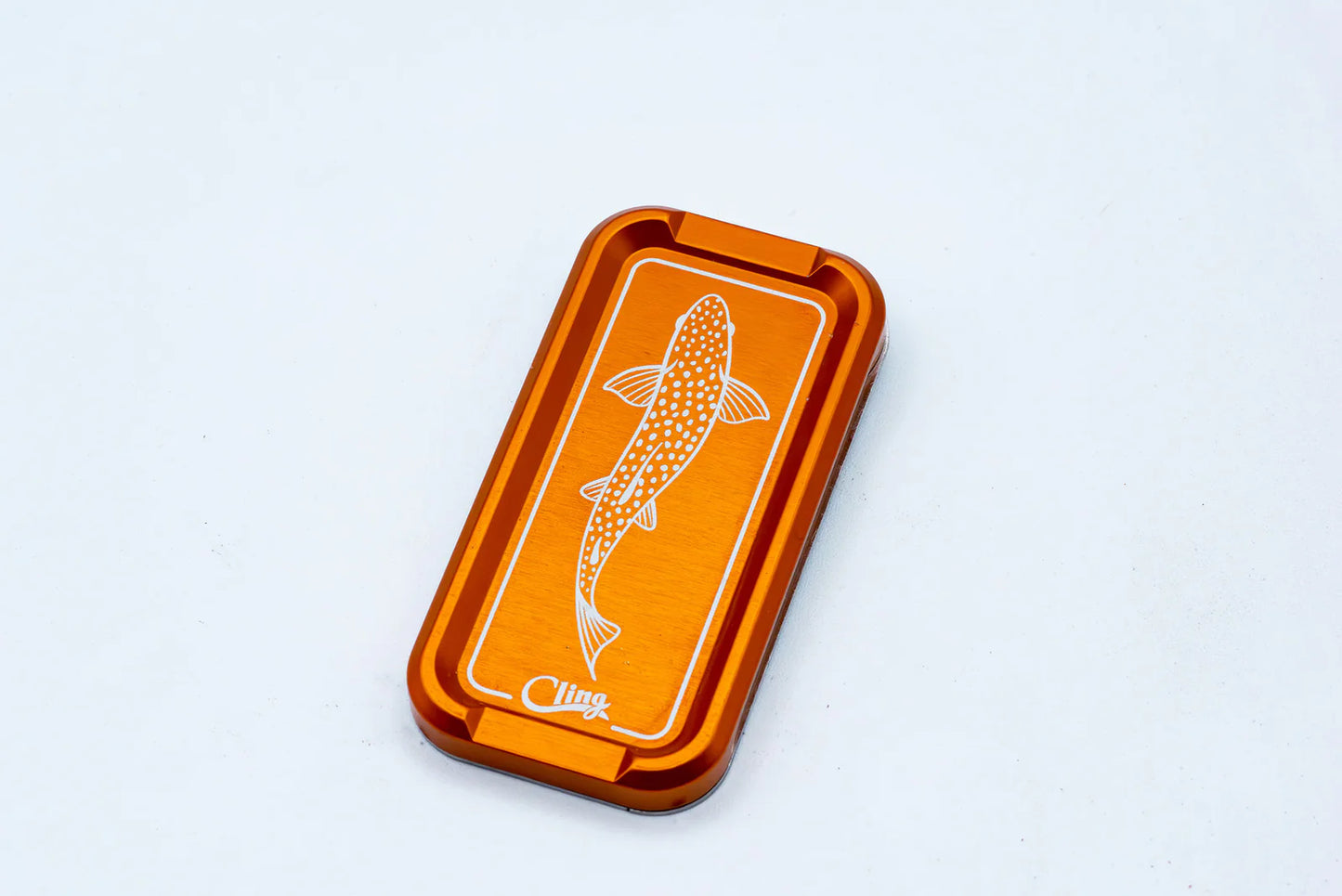 Cling Mag Grab Double Stack in bright orange with etched trout detail on the anodized aluminum surface.