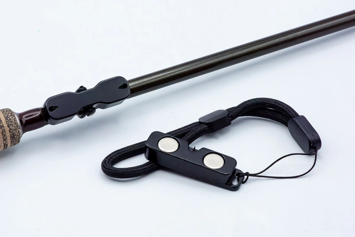 Black Cling Rod Rack Set mounted on a rod beside its matching magnetic leash.