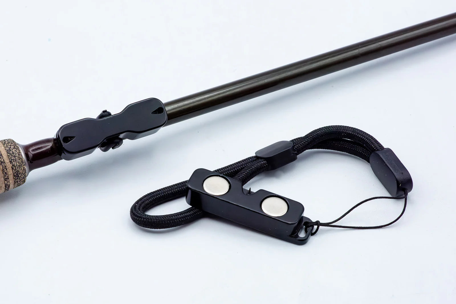 Black Cling Rod Rack Set mounted on a rod beside its matching magnetic leash.