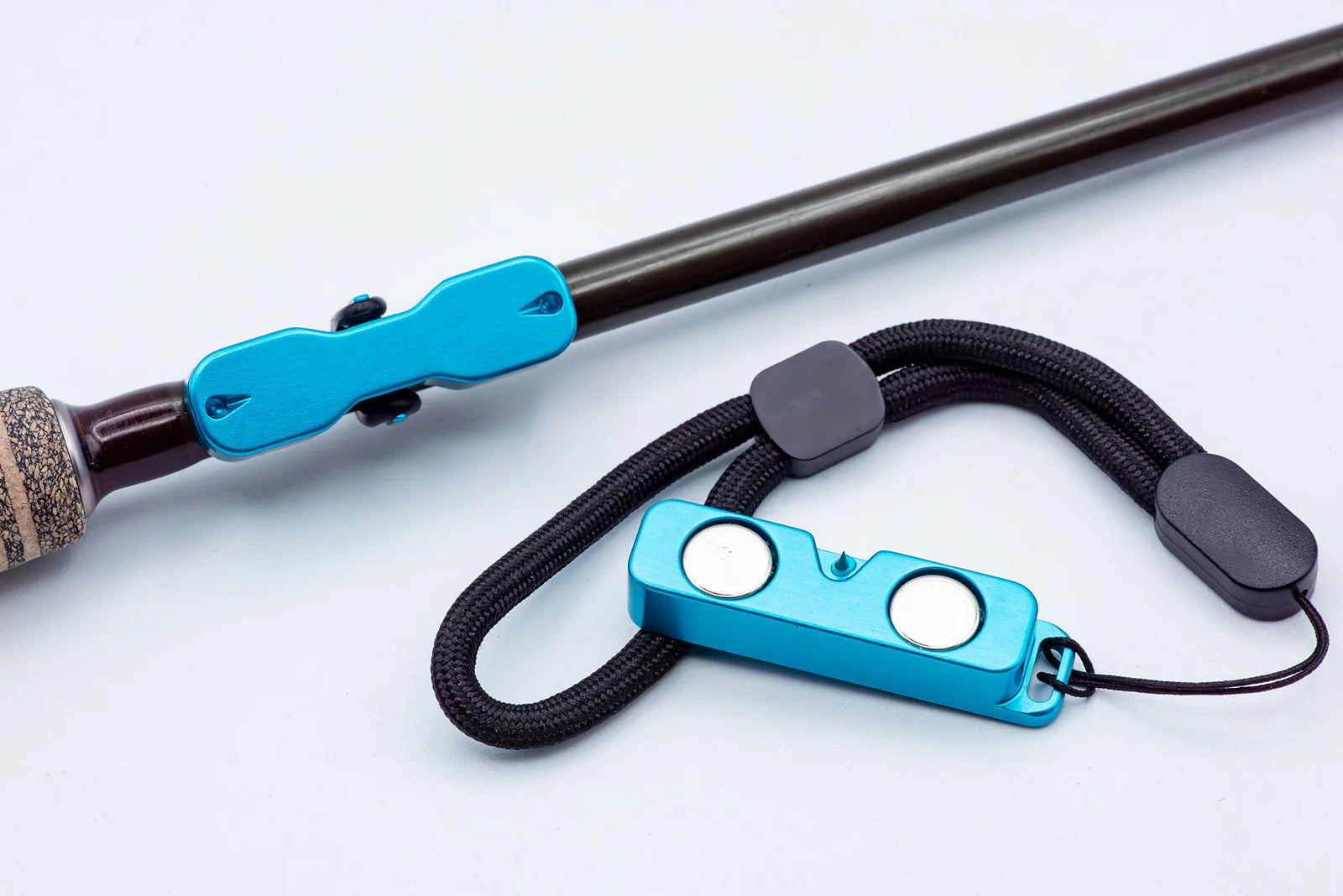 Blue Cling Rod Rack Set clipped to a fly rod with its magnetic lanyard beside it.