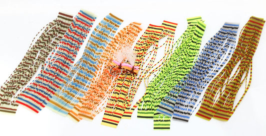 assorted triple barred heavy duty silicone legs by Hareline in various vibrant colors laid out in a fan shape.