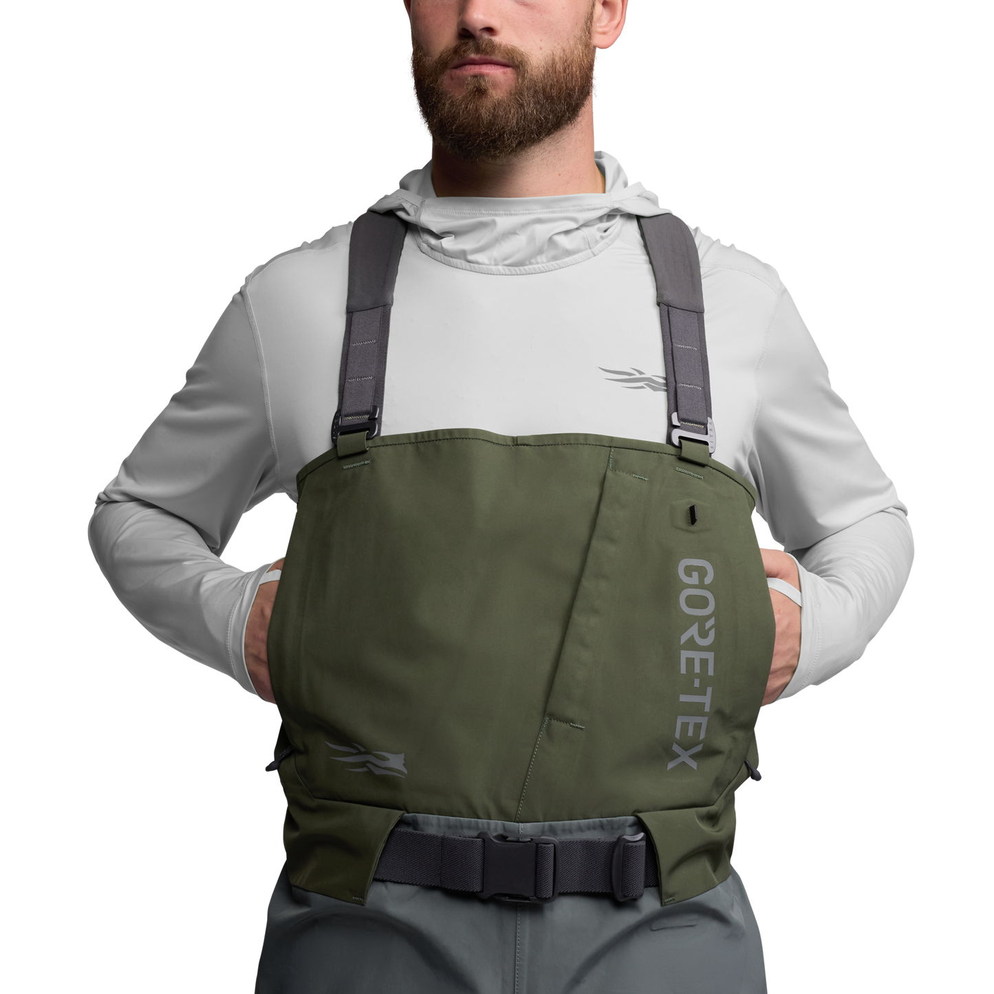 Front view of the Sitka Crosscurrent GTX Stockingfoot Wader worn by a model with hands in chest pocket.