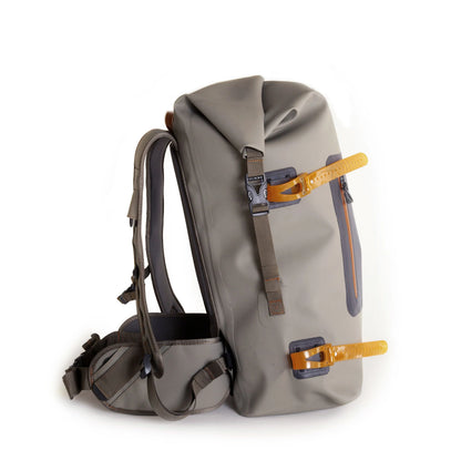 Side profile of the Wind River Roll-Top Backpack by Fishpond, showing rod straps and durable design.